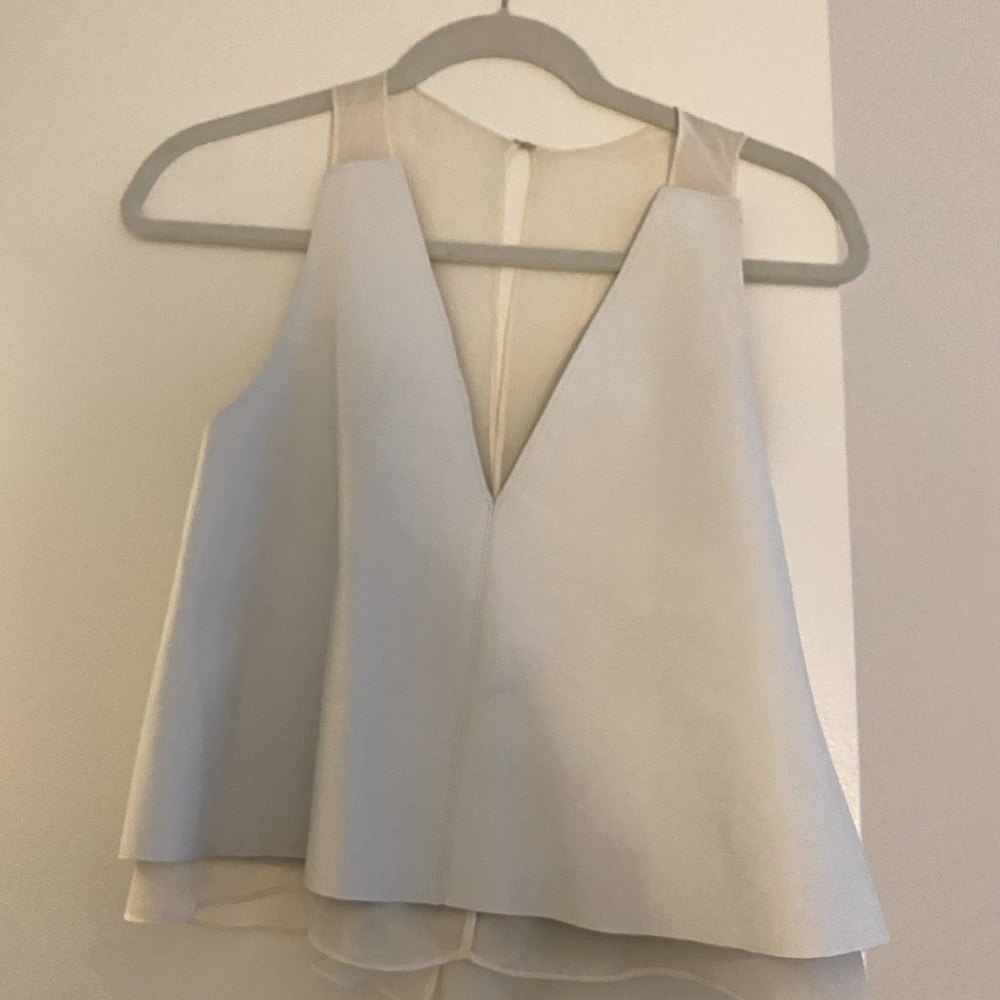White leather top with sheer back.